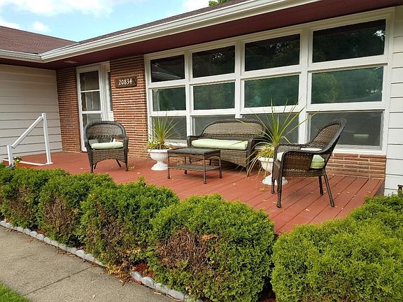 Front of home offers a quaint sitting area to enjoy your morning coffee.