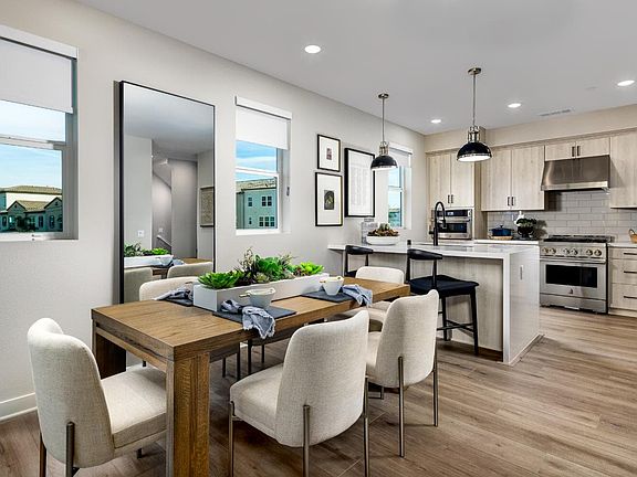 An image of the Dining and Kitchen in the Plan 3 model home at Magnolia in Arcadia.