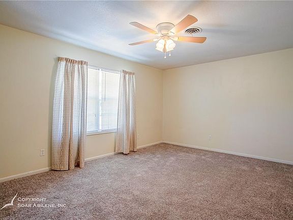 Living room with natural lighting fresh paint and new carpet.