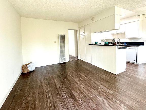 Spacious living room looking into the kitchen