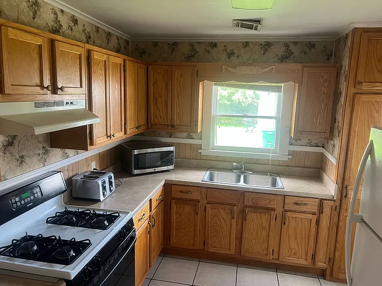 Quaint kitchen with old wallpaper