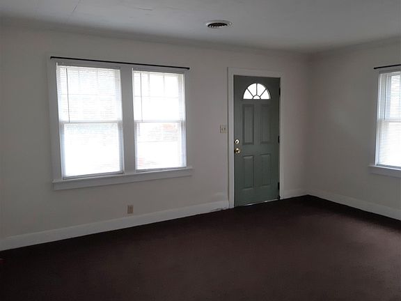 Living room with front entrance has a lot of natural light.