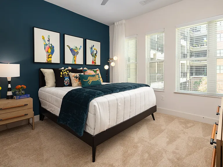 Stylish Bedroom with Accent Wall, Plush Carpet, and Bright Natural Light