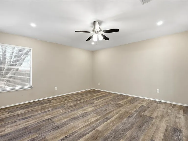Spare room featuring light wood-style floors, ceiling fan, and recessed lighting