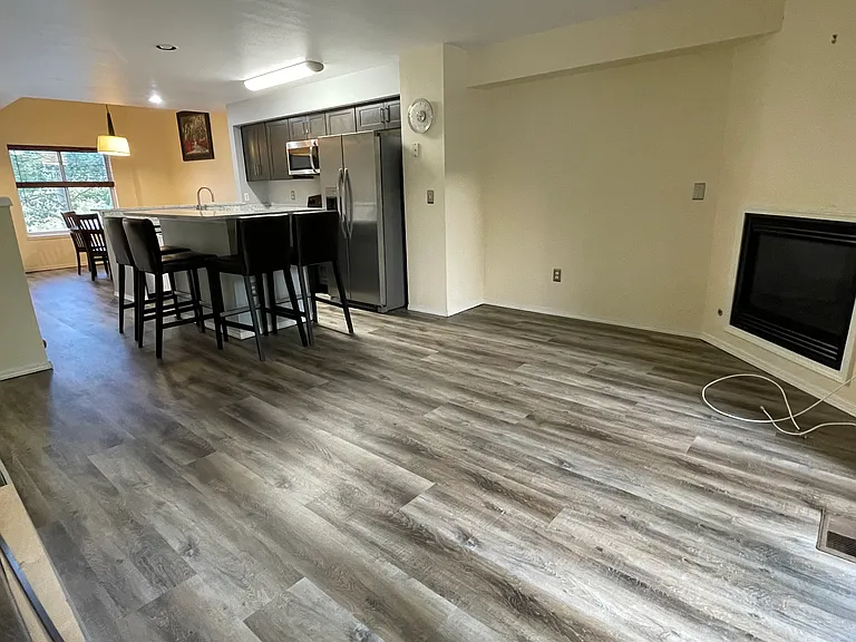 Lounge with new flooring and gas fireplace