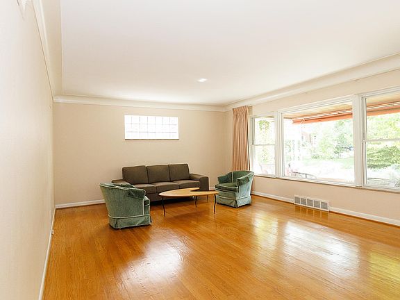 Front room is very large, 23 ' x 14' 6" with sweeping picture window overlooking the center island. Original owner kept a white baby grand piano beneath the glass block window.