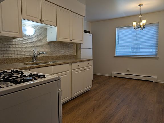Kitchen with new floor, lighting, granite countertop, and stainless steel sink