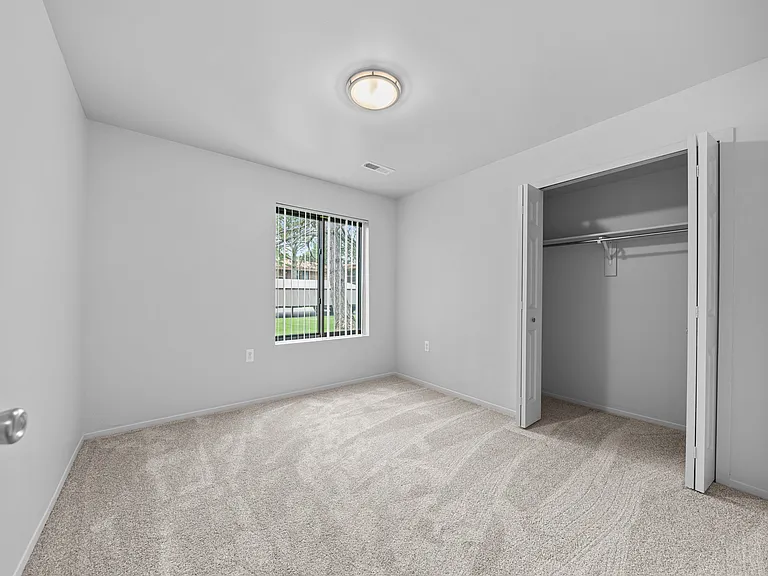 Big bedroom with natural lighting at Westwood Village Apartments in Westland, MI
