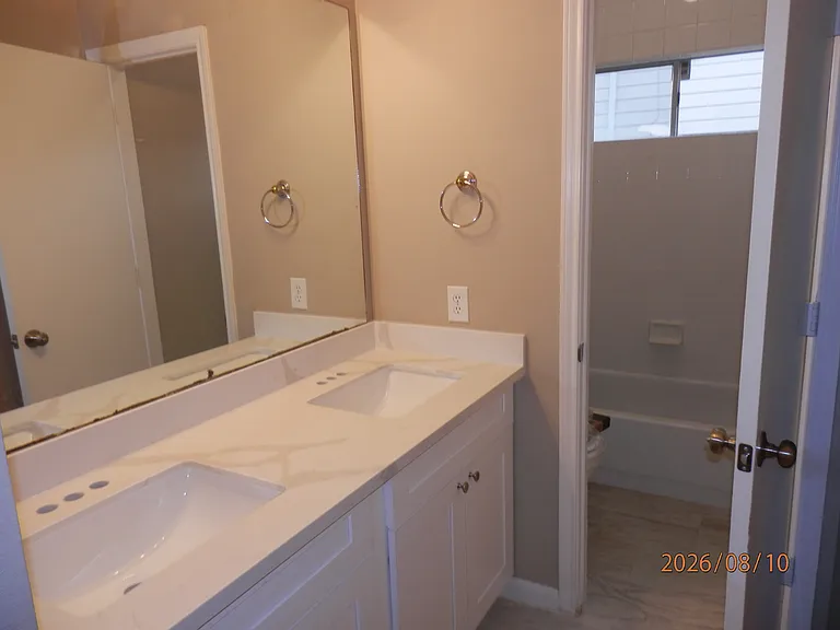 Hall bathroom with double sinks. New vanity cabinet and quartz countertop