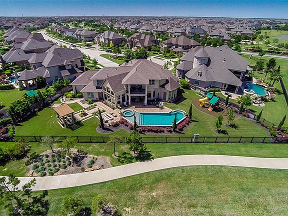 The Elegant Estate homes features a sparkling pool, fire pit, and over 200 feet of water frontage