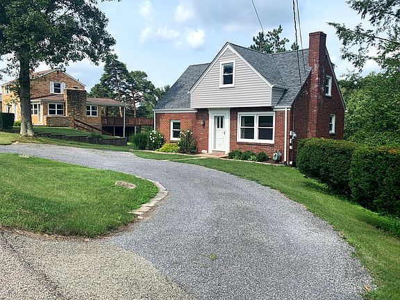 Circular gravel driveway provides parking for 2-3 cars.