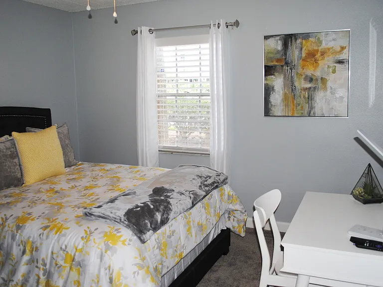 Staged bedroom with a queen-size bed