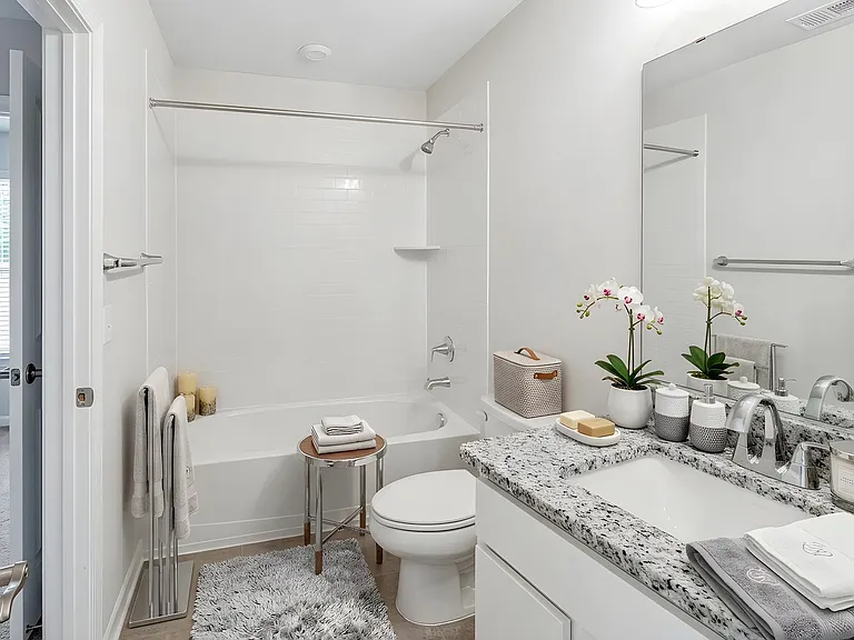 Private full bathroom serving the entry-level bedroom, ideal for guests, family members, or a dedicated home office setup. Virtually staged.