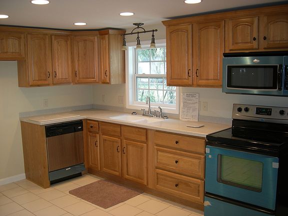 kitchen with corian counters, custom cabinets, and new appliances 