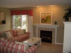 Family Room w Gas Fireplace and Window Treatments and Walk-out to Patio