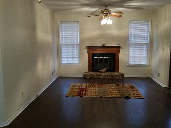 Living room with wood burning fireplace.