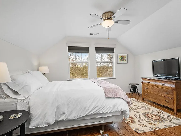 Primary Bedroom with Queen Bed. Windows overlook street and Lynch Creek.