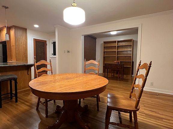 Currently, without tenants, kitchen on left, front door on right, office beyond dining area