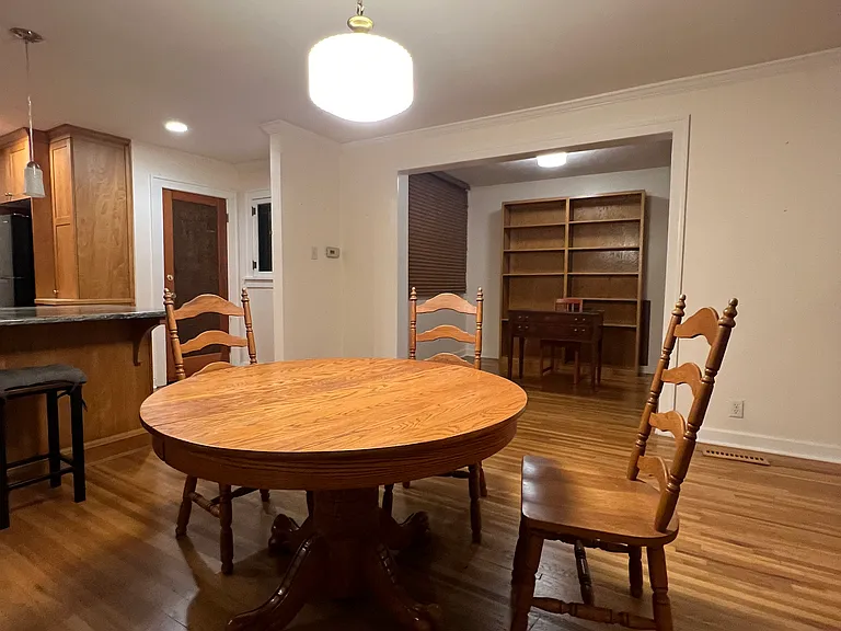 Currently, without tenants, kitchen on left, front door on right, office beyond dining area