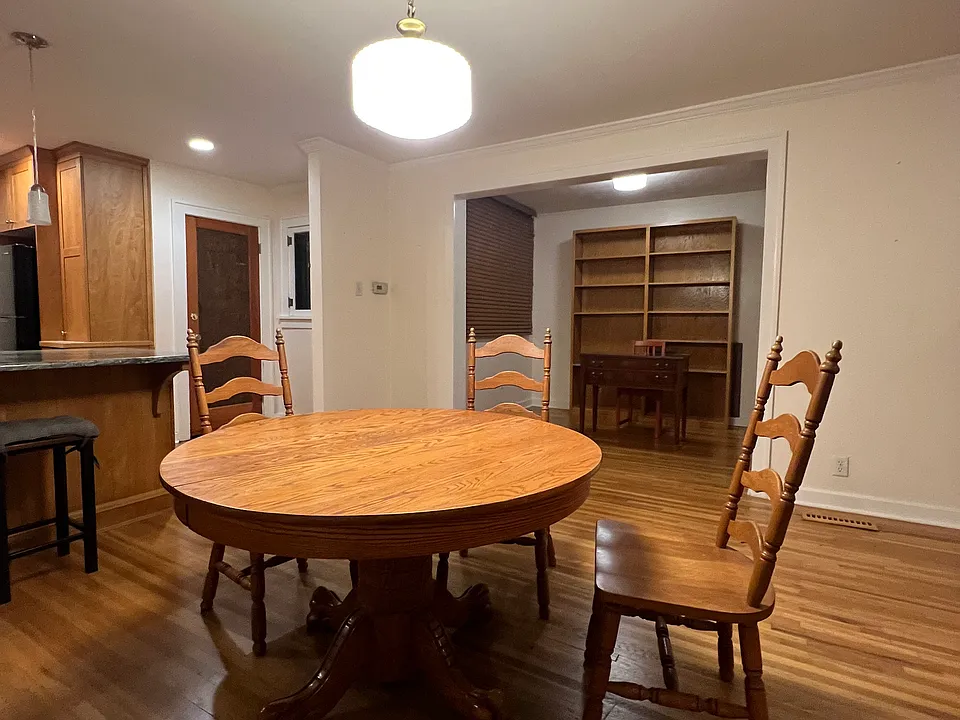 Currently, without tenants, kitchen on left, front door on right, office beyond dining area