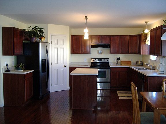 Cherry and stainless kitchen with custom lighting
