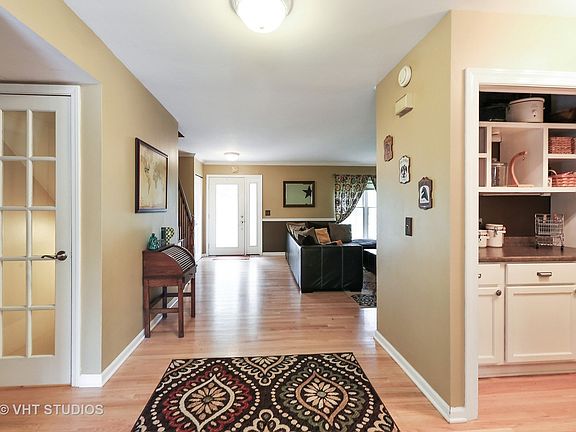 Double Wide entry way with hardwood floors. Open glass doors to basement. Butler pantry.