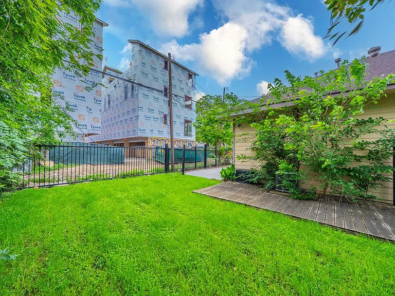 Relax on the back deck with a peaceful view of the green lawn.