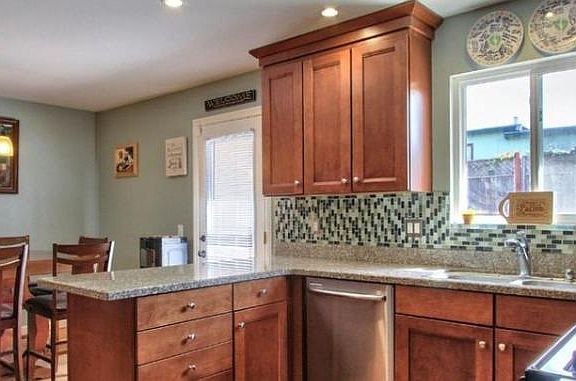 Kitchen with beautiful granite countertops and tile back drops.