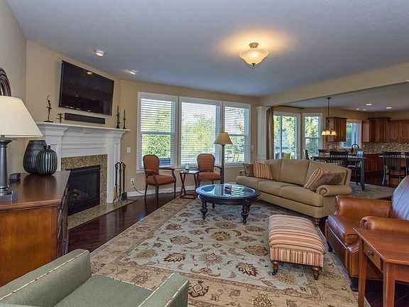 Large family room with gas fireplace and granite surround.