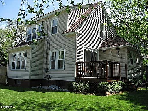 Fenced in backyard with deck