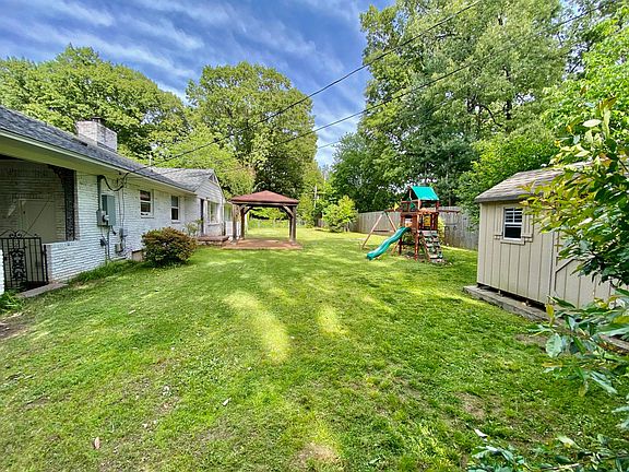 Large backyard with shed, playlet and covered patio