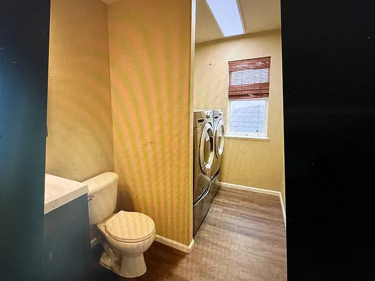 Main level half-bath and laundry.