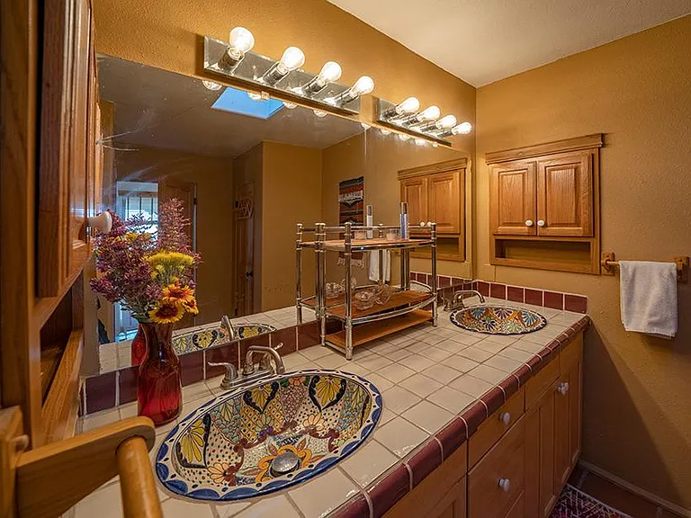 Master bathroom with Santa Fe accents and skylight.