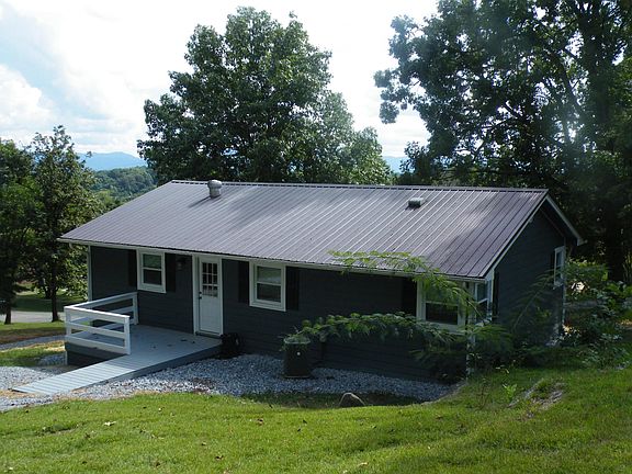 Rear deck with handicapped ramp. Two car parking in rear of home.