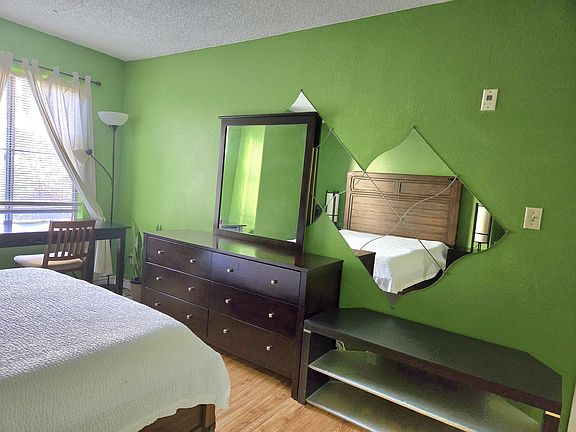 There's a dresser, table, and TV stand.