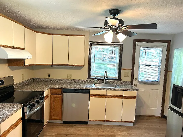 Kitchen, which is large enough for eating in with table and chairs.