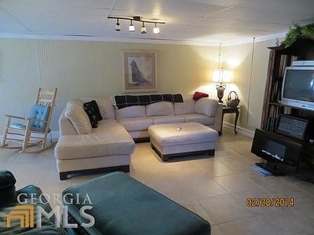 Tiled floors, modern leather coach, spacious living room,