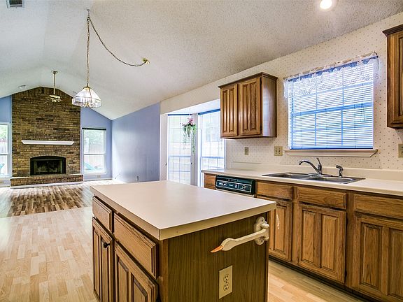 And open to the kitchen with center island and lots of counter tops.