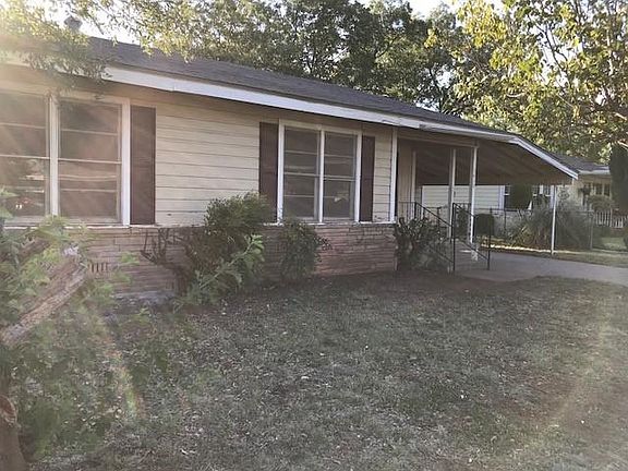 Front Exterior. Carport and Garage.