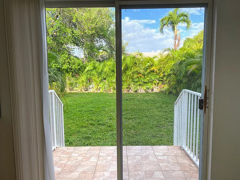 Back porch and fenced-in backyard