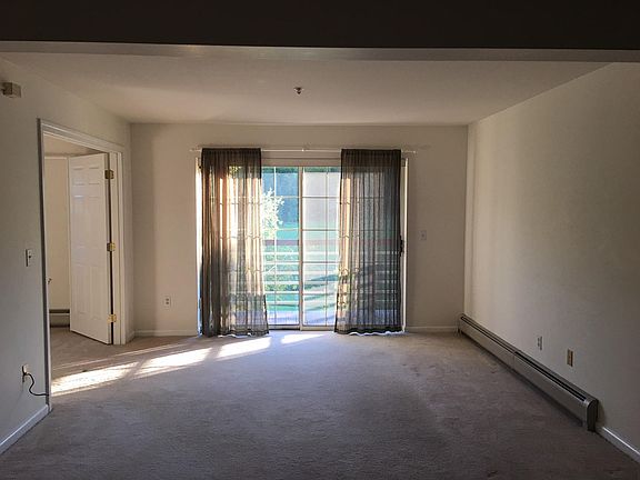 Living Room and balcony overlooking the field with bedroom off to the left