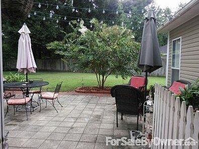 Large fenced in back yard with a 20X25 cement paver patio and a 24x32 workshop.