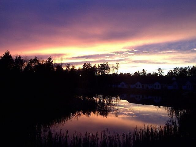 Sunset over the pond (six windows offer this view).