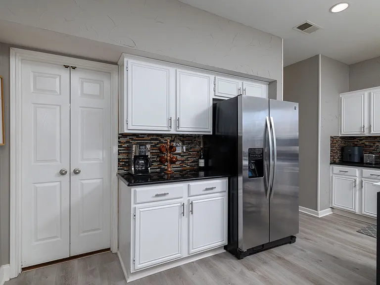 Bright, modern kitchen with a sleek island and cozy dining area.