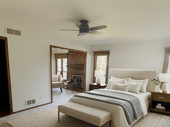 master bedroom with cozy fireplace and sitting area