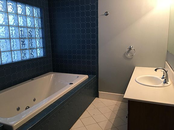 Down stairs bath (Showing Jacuzzi tub with vanity. 