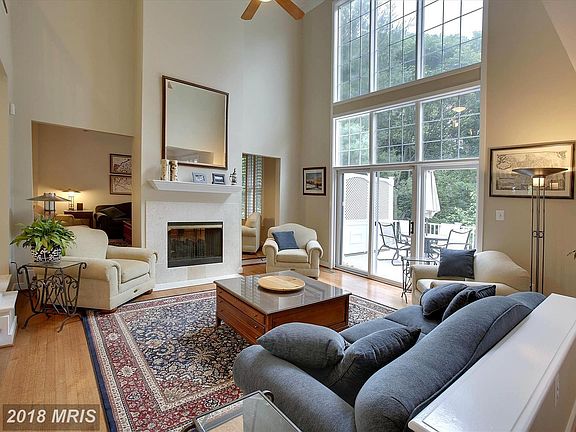 Family Room w/ floor to ceiling windows & FP