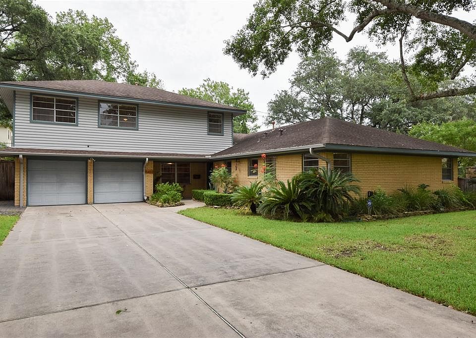 Lovely elevation from street- beautiful treed lot + manicured yard