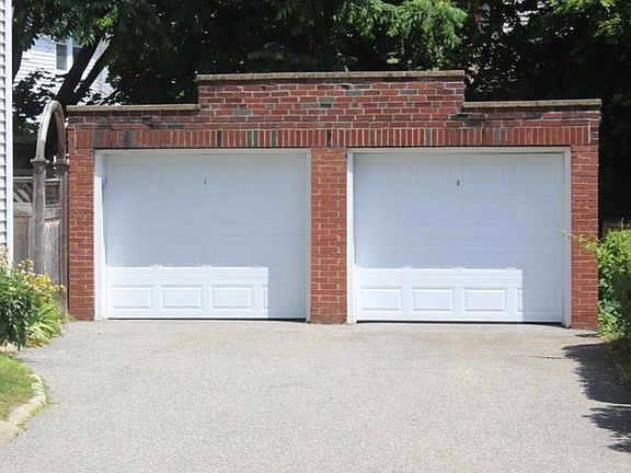 1 parking spot in the renovated brick garage, with new remote-controlled doors, and additional generous driveway parking.