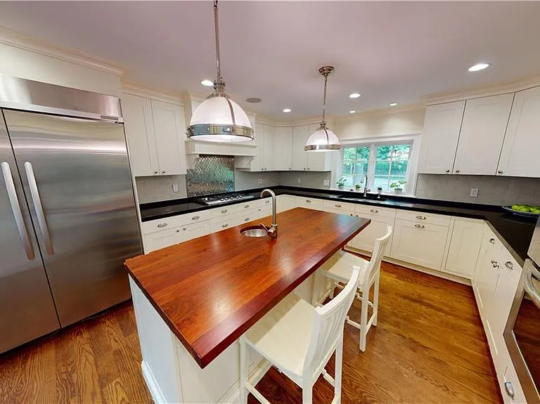 Modern hi-end chef's kitchen with stainless appliances and Bilotta custom kitchen cabinetry